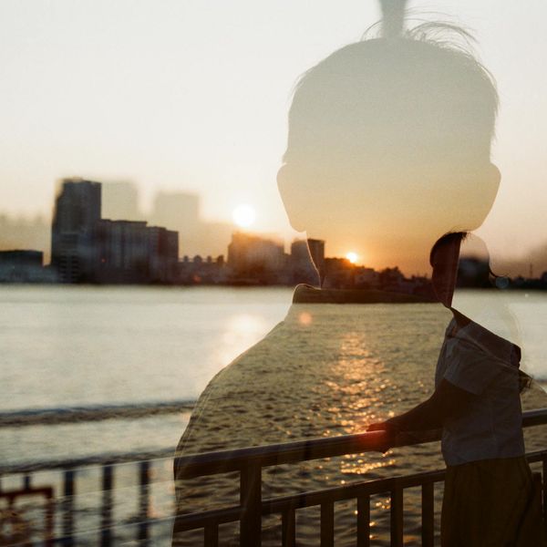 Silhouette of a person meditating against a sunset background.